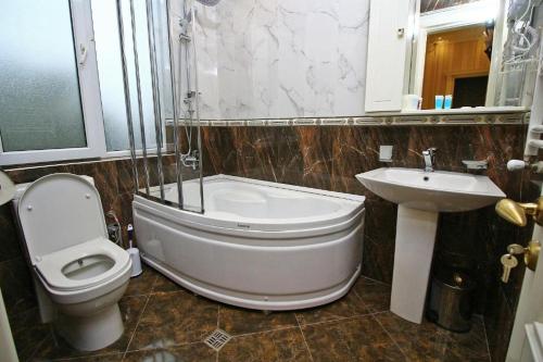 a bathroom with a toilet and a sink at Sanata in Tbilisi City