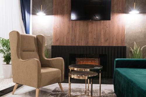 a living room with a chair and a table at Неймовірний пентхаус "Сьоме небо" in Uzhhorod