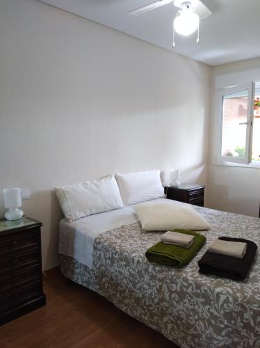 a bedroom with a bed with two pillows on it at Apartamento Turístico Príncipe Cáceres AT-CC-00415 in Cáceres