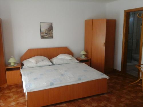 A bed or beds in a room at Petrovics Apartmanház