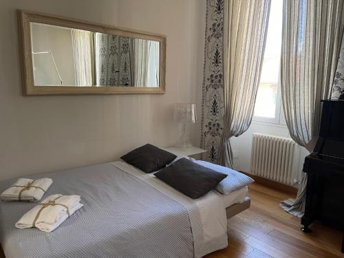 a bedroom with a bed with a mirror on the wall at Casa Bocchi 3 in Florence