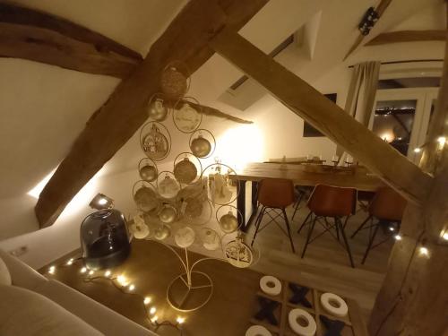 a room with a table and chairs and a dining room at Le grenier de Charlotte in Libin