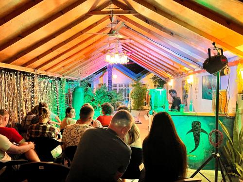 a group of people sitting in a room with a stage at Manta Stay Thoddoo, Maldives in Thoddoo