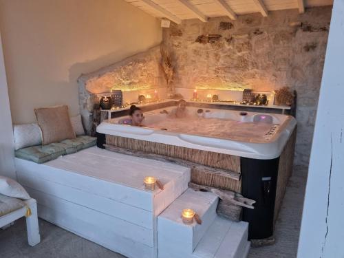 two people in a bath tub in a room at mazet provençal in Saint-Gilles