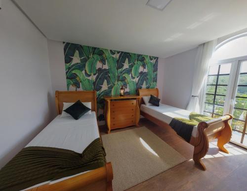 Cette chambre comprend 2 lits et une fenêtre. dans l'établissement Vila Pugliesi Hotel Boutique, à Lençóis