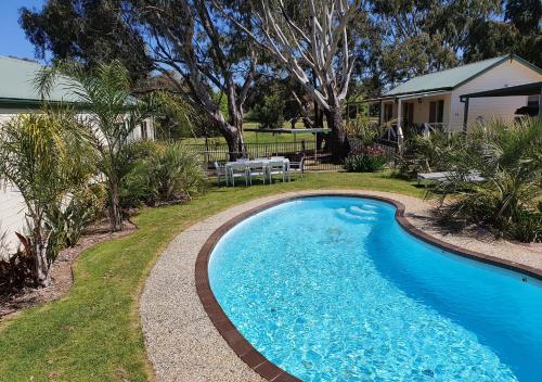 a swimming pool in the yard of a house at Golden Heritage Accommodation in Beechworth