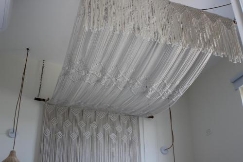 a white curtain hanging from a ceiling at אבן על הנחל in Merhav Am