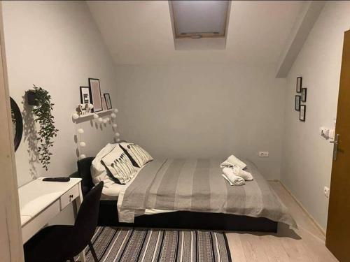 a bedroom with a bed and a dresser in it at VonAmor Rooms in Novi Sad
