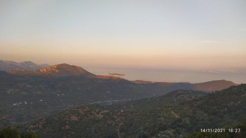 a view of the mountains with the ocean in the distance at Traditional Windmill-Milos in Kroústas