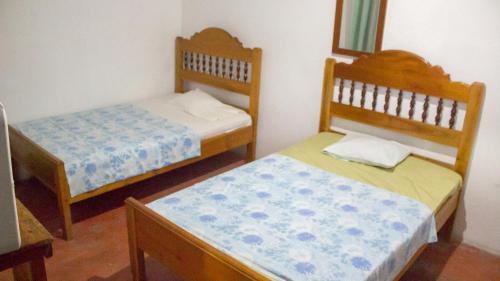 Una cama o camas en una habitación de Hotel Rabin Itzam