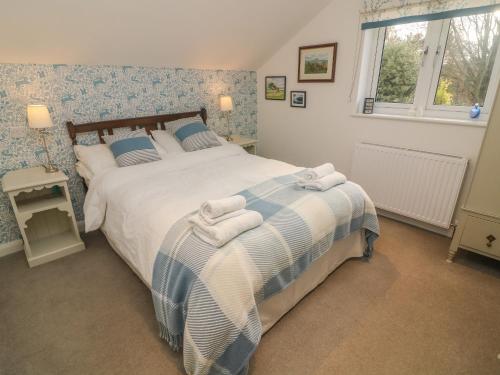 a bedroom with a bed with towels on it at Carwood in Dufton