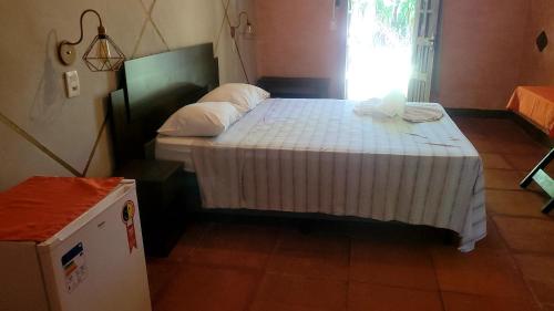 Un pat sau paturi într-o cameră la Imbassaí Pousada Hostel Lujimba