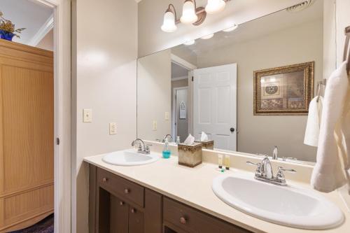 a bathroom with two sinks and a large mirror at Brenda Lee History 4BR Retreat Pool Hot Tub in Nashville