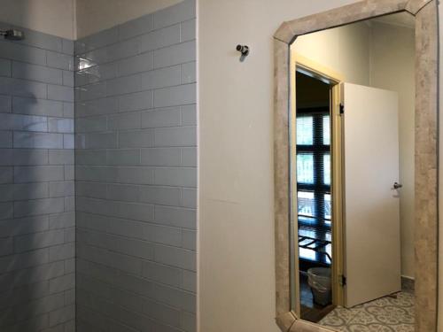un baño con espejo y ducha en Grey Gum Lodge, en Nimbin