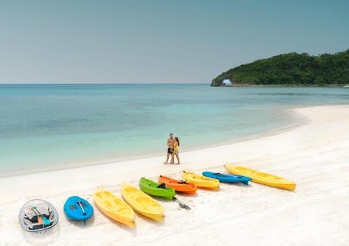 a group of kayaks lined up on a beach at Belmont Hotel Boracay near Newcoast Beach in Boracay