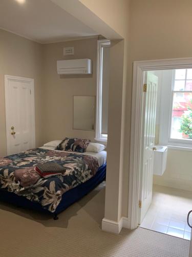 a bedroom with a bed and a window at Northlodge Central City Apartments in Perth