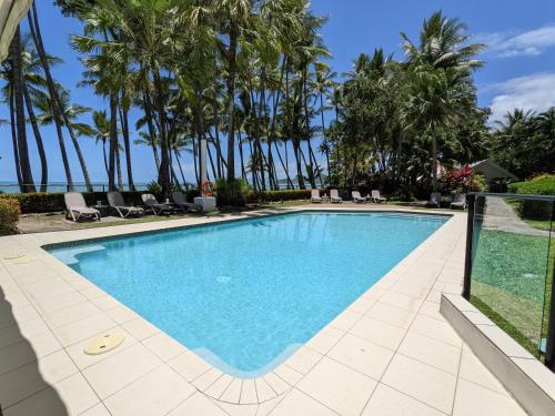 a pool with a pool table and chairs in it at Alamanda Palm Cove by Lancemore in Palm Cove
