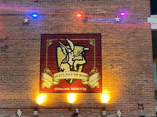 a sign on the side of a brick building at Hermann Crown Suites in Hermann