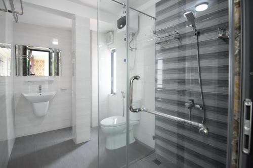 a bathroom with a shower and a toilet and a sink at HAPPY GUEST HOUSE in Hai Phong