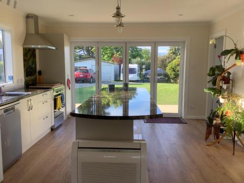 a kitchen with a large island in the middle of it at Tui Cottage in Hampden