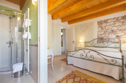 a bedroom with a bed and a walk in shower at Talamo Rooms in San Martino Buon Albergo