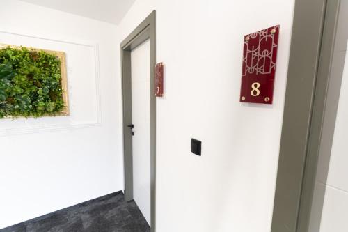 a room with a door and a painting on the wall at SAVOY residence in Osijek