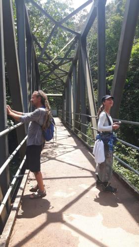 two women are standing on a bridge at Sinharaja Vini Villa in Deniyaya