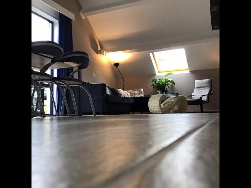 a living room with a couch and a table at Enjoy Durbuy 1 in Durbuy