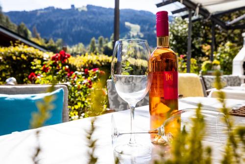 a bottle of wine sitting on a table with a glass at Sportpension Bergblick in Wagrain