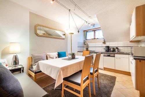 a kitchen and dining room with a table and chairs at Sportpension Bergblick in Wagrain