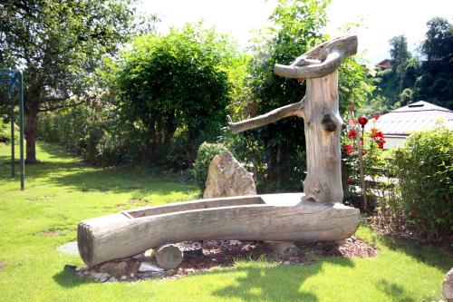 a statue of a birdbath in a garden at Sportpension Bergblick in Wagrain