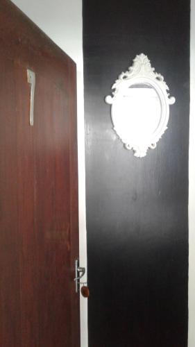a black door with a whitereath on a wall at Turtle Eco Beach in Matara