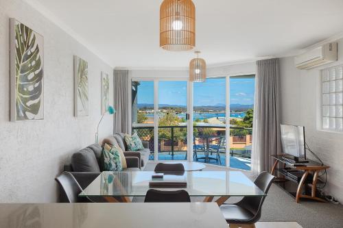 a living room with a couch and a table at The Palms Apartments in Merimbula
