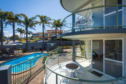 a balcony of a house with a swimming pool at The Palms Apartments in Merimbula