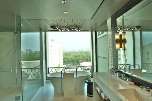 a bathroom with two sinks and a bath tub at InterContinental Dhaka by IHG in Dhaka