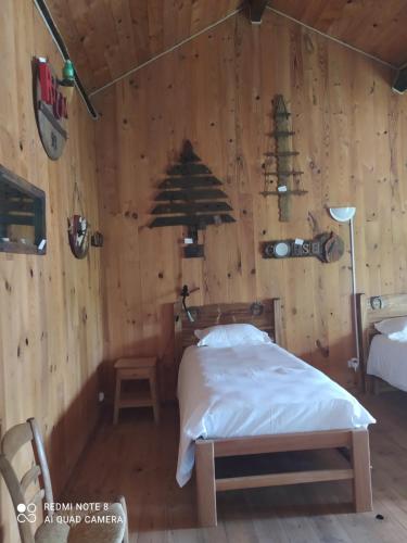 a bedroom with a bed in a wooden wall at le saloon in Chazey-sur-Ain