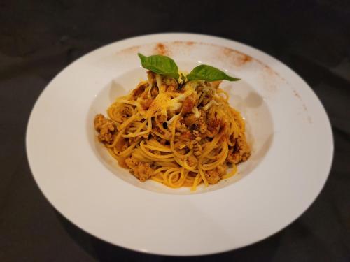 a plate of pasta on a white plate at Arachchi Heritage in Anuradhapura