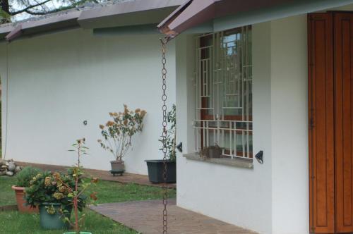 a porch of a house with a swing at B & B Chic in Premariacco