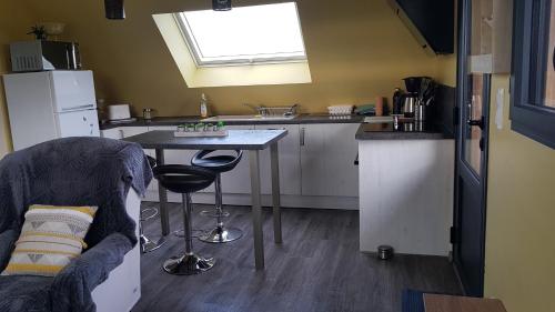 a small kitchen with a table and a sink at nid cauchois in Betteville