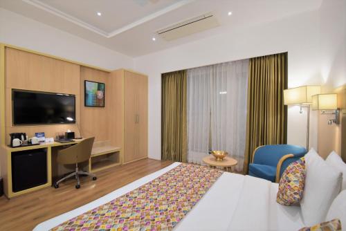 a hotel room with a bed and a desk at SureStay by Best Western Heritage Walk in Amritsar