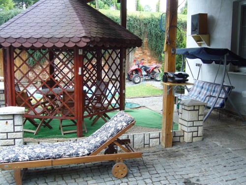 a gazebo with a chair in a yard at Apartmán Modré z nebe in Němčičky