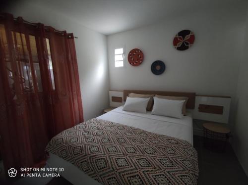 a bedroom with a large bed and a window at villa Areca in Saint-Joseph