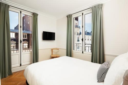 Säng eller sängar i ett rum på My Maison In Paris - Champ de Mars