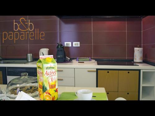 a kitchen with a carton of orange juice on a table at B&B Paparelle in Cosenza