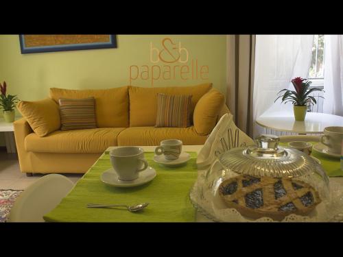 a living room with a table and a couch at B&B Paparelle in Cosenza