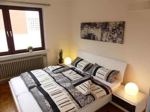 a bed with black and white pillows in a bedroom at Ferienhaus Strandlust in Butjadingen