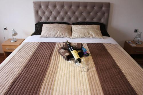 a bed with a bunch of items on it at Apartmani Ramonda in Teslić