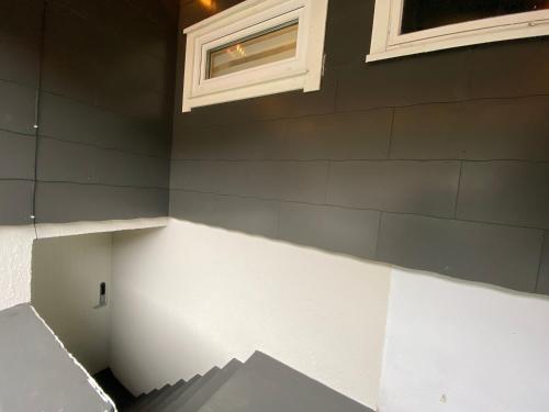 a wall of a house with a window and stairs at ÅNDALSNES UNDERGROUND flat in Åndalsnes