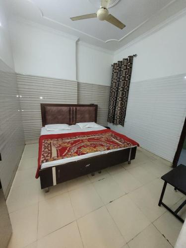 a bedroom with a large bed in a room at Asha Guest House in Amritsar