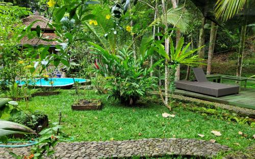 a garden with a bench and some plants at Mi Casa - The gem of Ijen in Banyuwangi